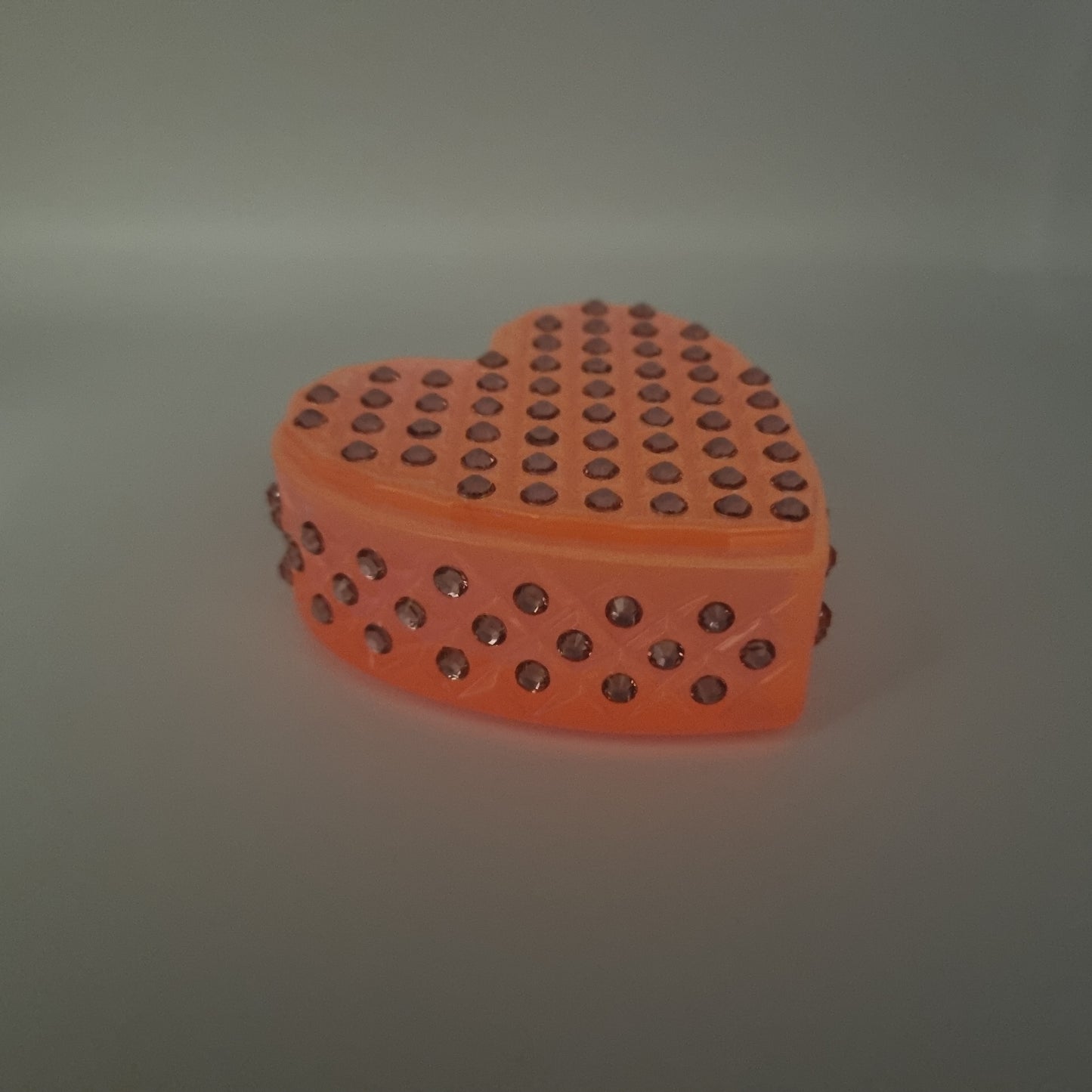 Glow-In-The-Dark Pretty Pink Heart Shaped Box, with the light turned down.