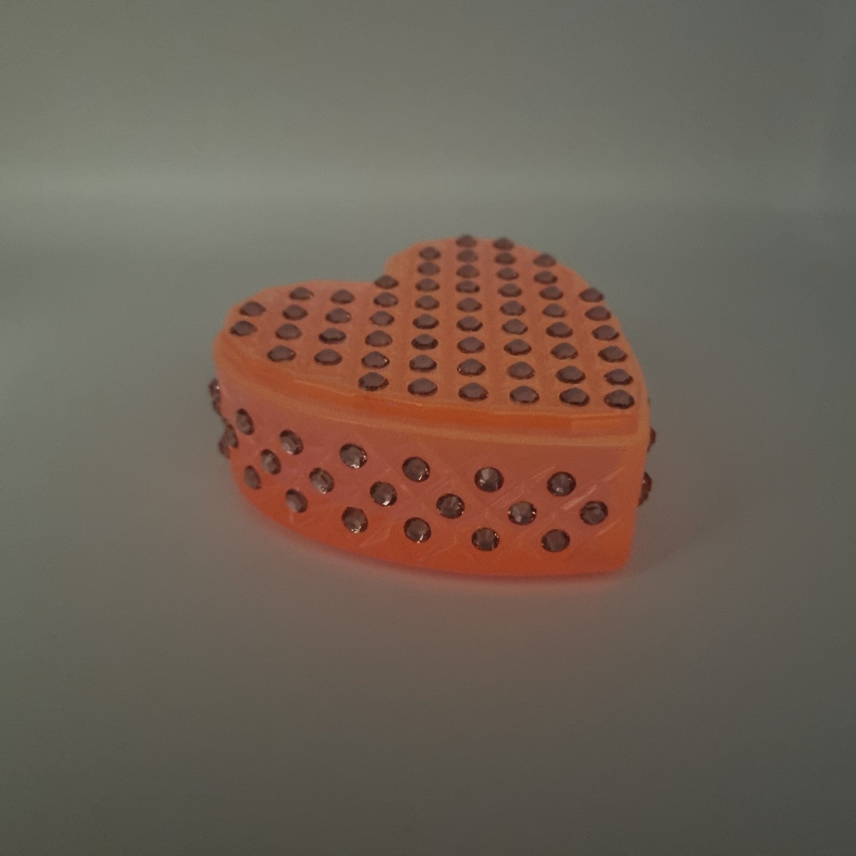 Glow-In-The-Dark Pretty Pink Heart Shaped Box, with the light turned down.